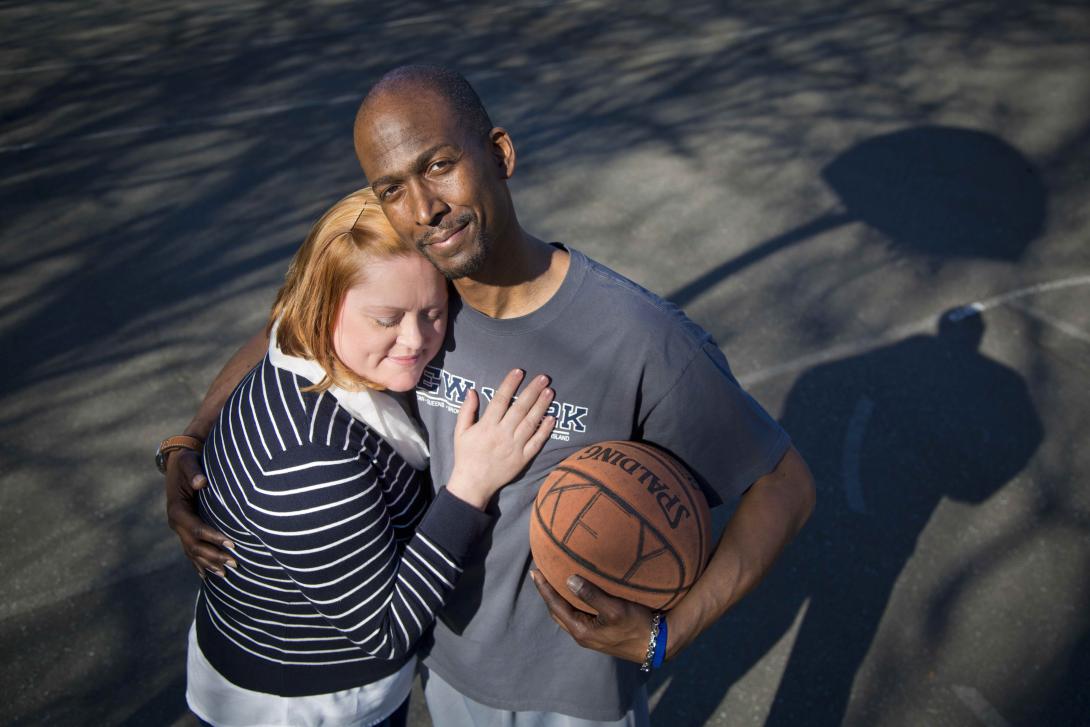 Narciscus Key hugs his wife and a basketball