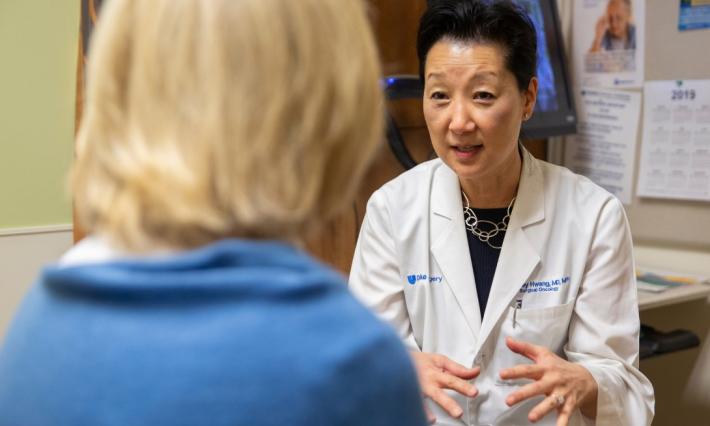 Shelley Hwang, MD, MPH is talking to a patient whose back is turned to the camera