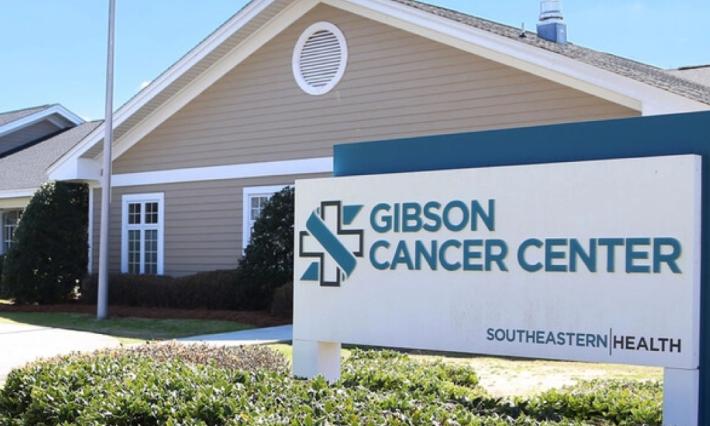 building with triangle roof and sign reading "Gibson Cancer Center, Southeastern Health"