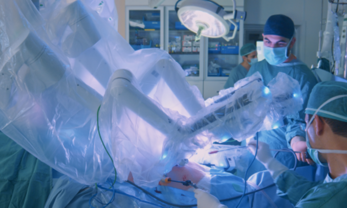 Surgeon doing laparoscopic surgery in hospital with a medical robot