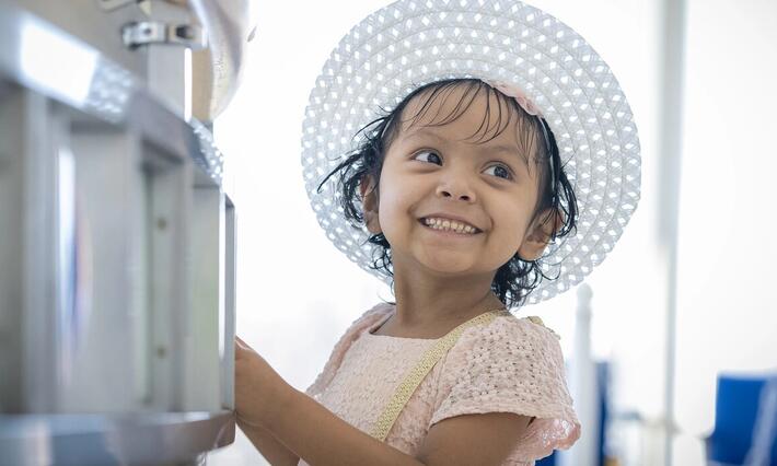 Sophia Ramirez smiles in the lobby at Duke Children's Hospital.