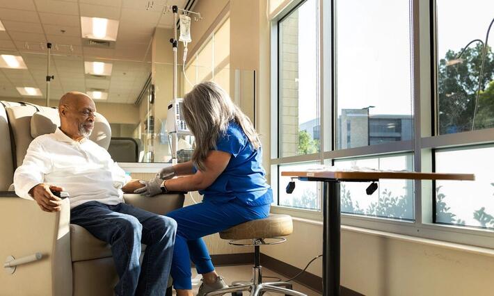 A nurse sets a patient up for an infusion