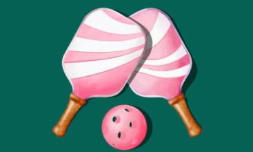 two pink pickleball paddles and a pickleball 