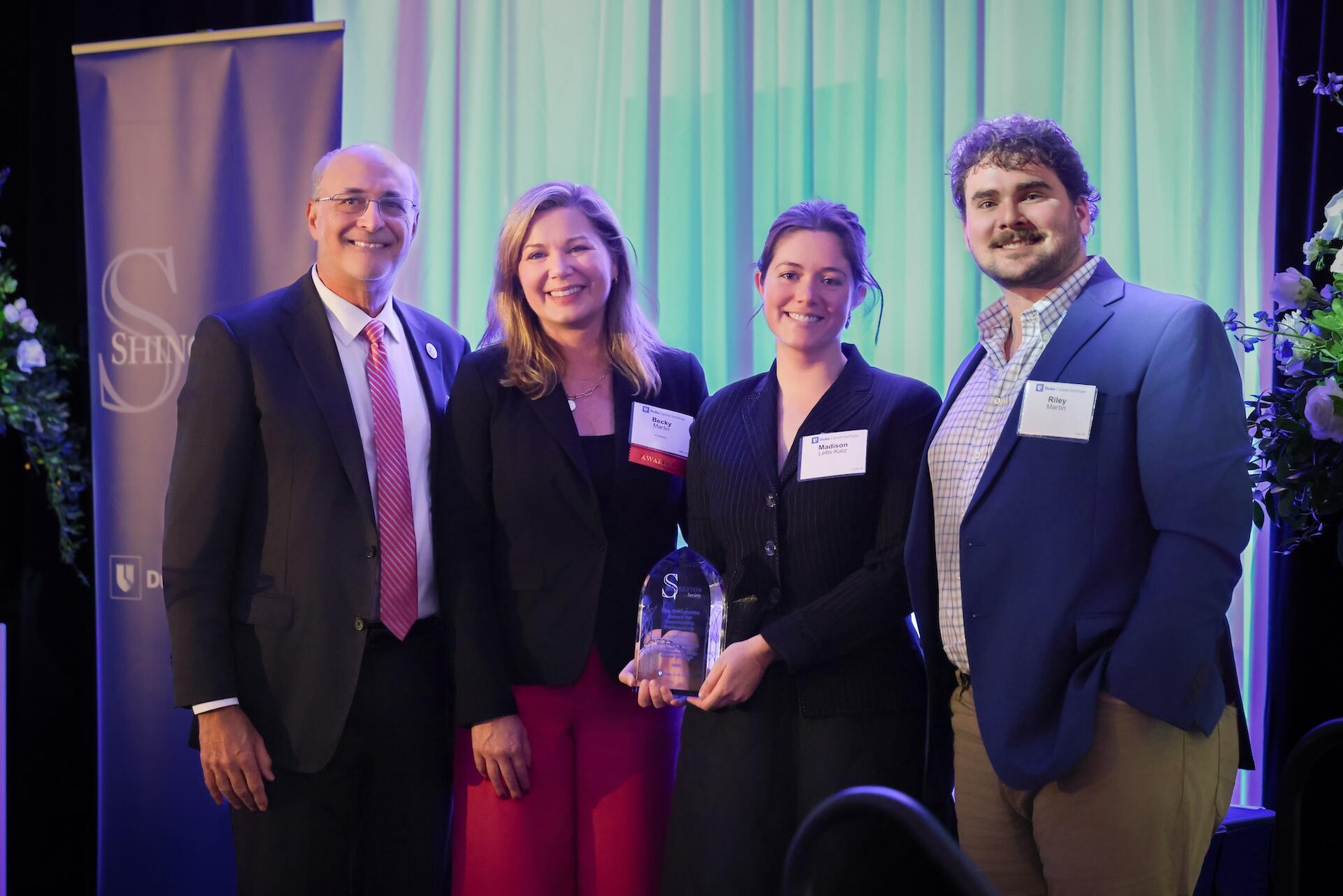 2.	A group of three from the Knox Martin Foundation receiving congratulations from Michael Kastan.