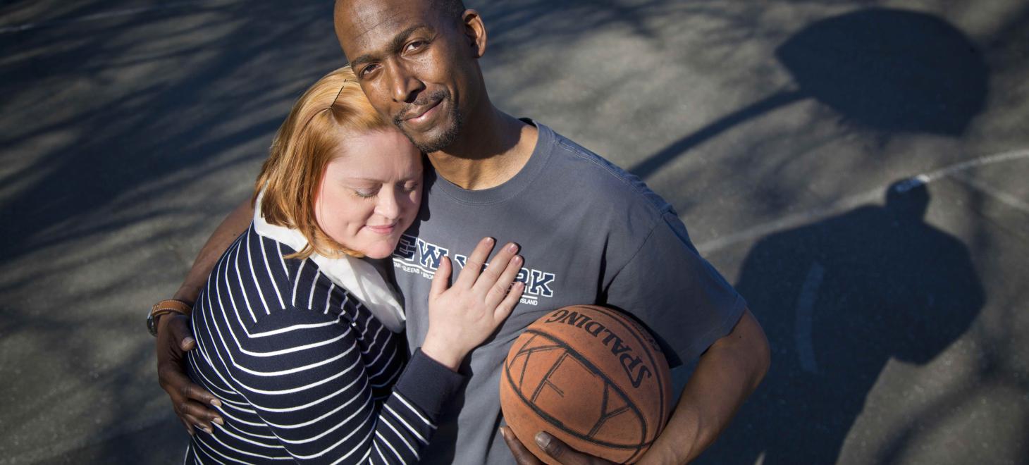 Narciscus Key hugs his wife and a basketball