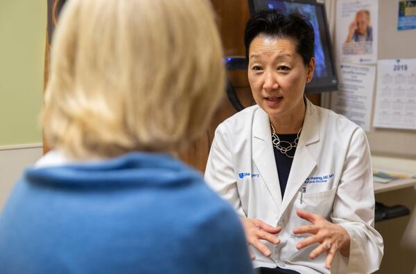 Shelley Hwang, MD, MPH is talking to a patient whose back is turned to the camera