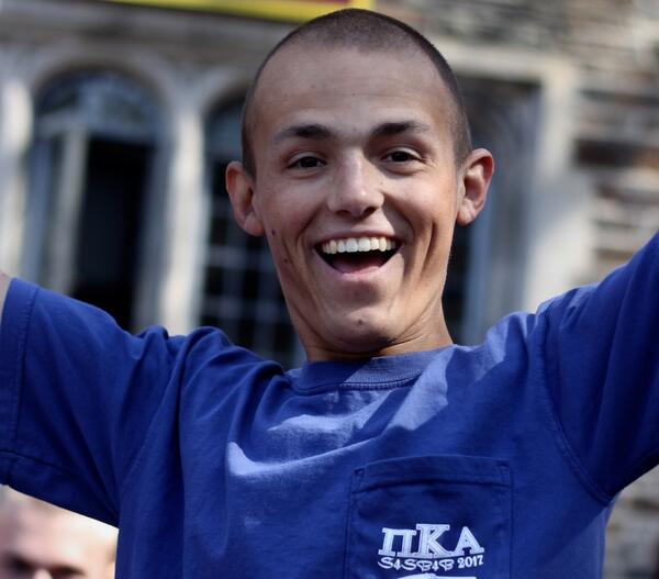 Bobby Menges smiling with his arms raised