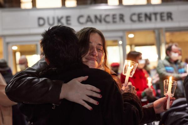 Tree of Hope attendees hug at the tree lighting ceremony honoring those whose lives have been affected by cancer. 