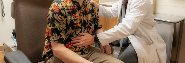 Dr. Devito examining a patient in clinic