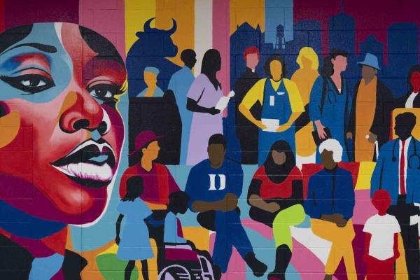 Mural of a woman's face surrounded diverse individuals from around Duke