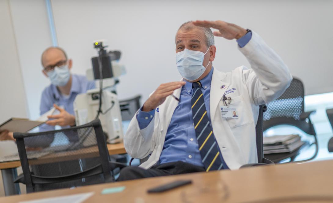 Man in white coat and surgical mask