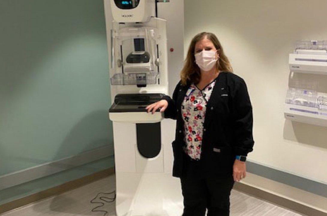 Ginger Connor standing at a mammogram machine