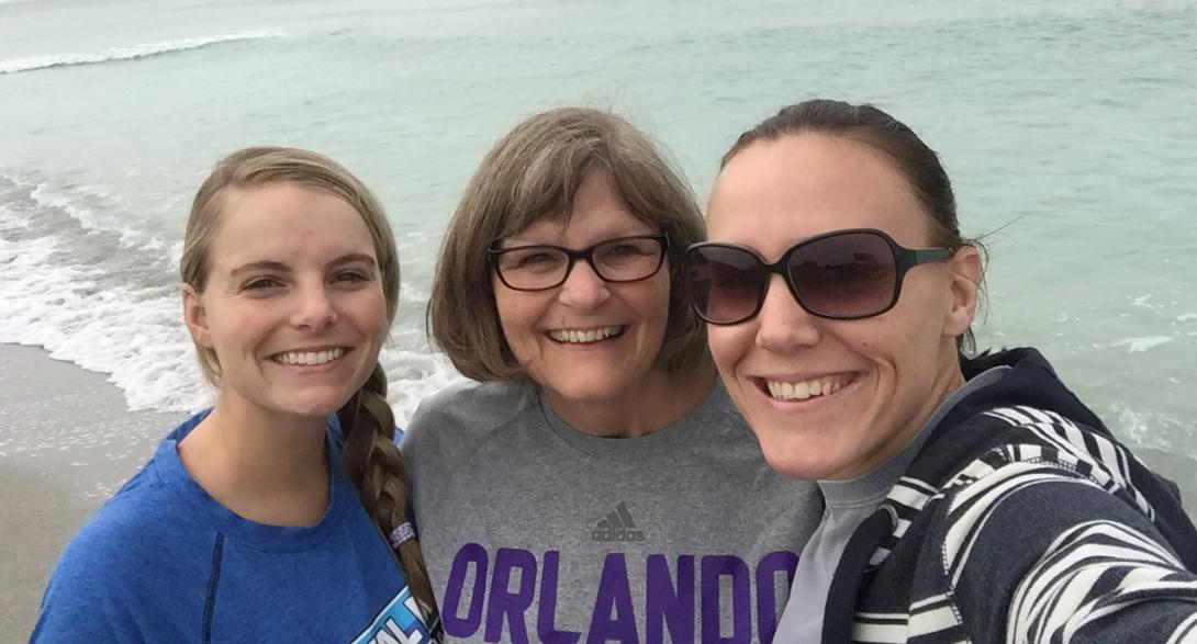 Pat Smith smiles with her two daughters at the beach.