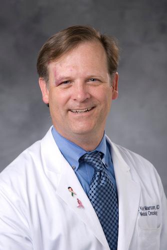 Man in white doctor's coat smiling