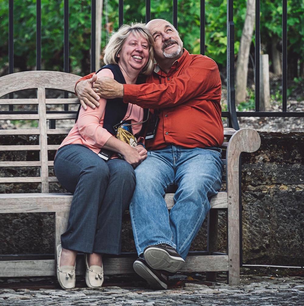 Heather Paradis and her late husband, Eric Paradis, hug on a park bench.