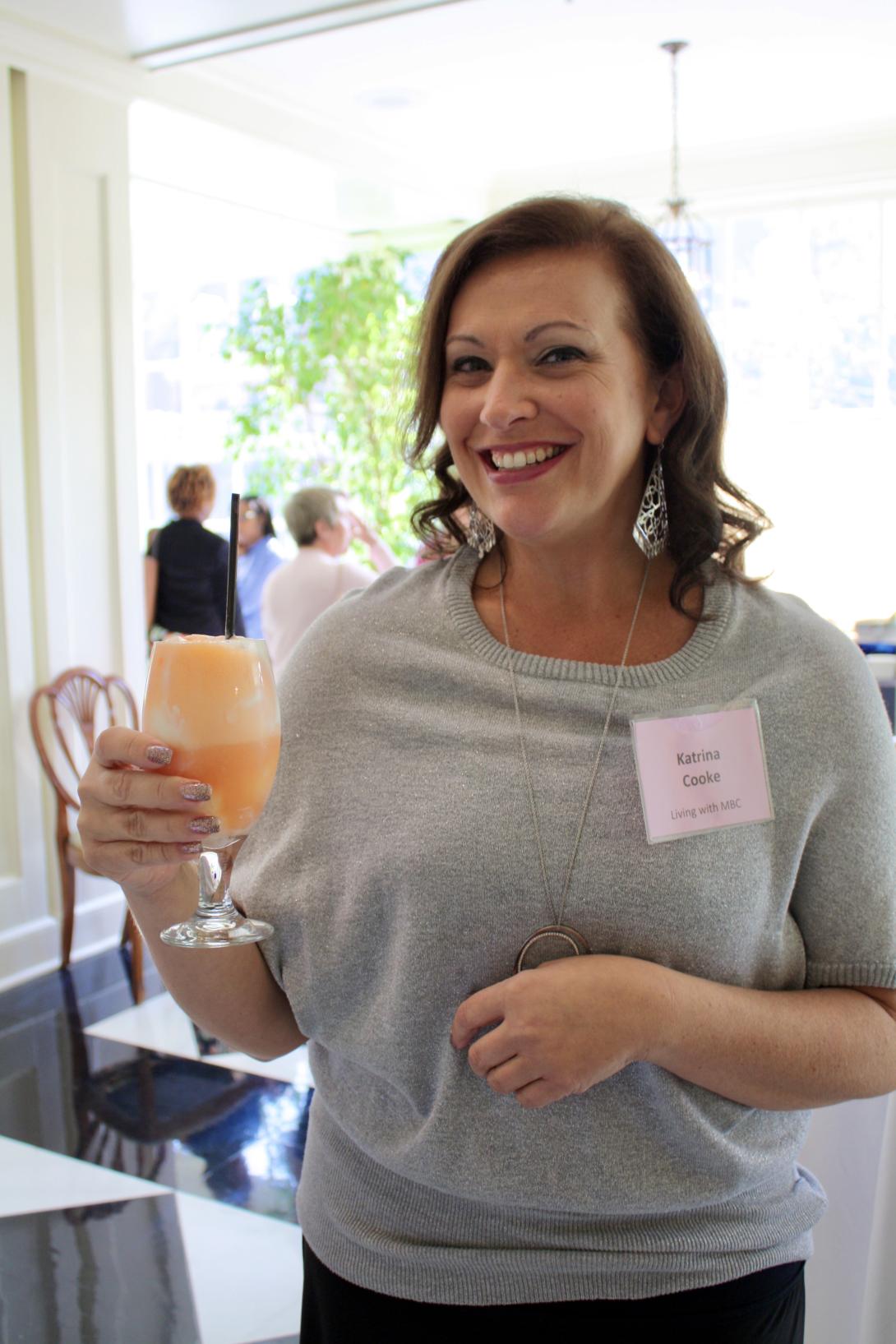 Katrina Cooke enjoys a fruity drink at a breast cancer research breakfast hosted by Susan G. Komen North Carolina Triangle