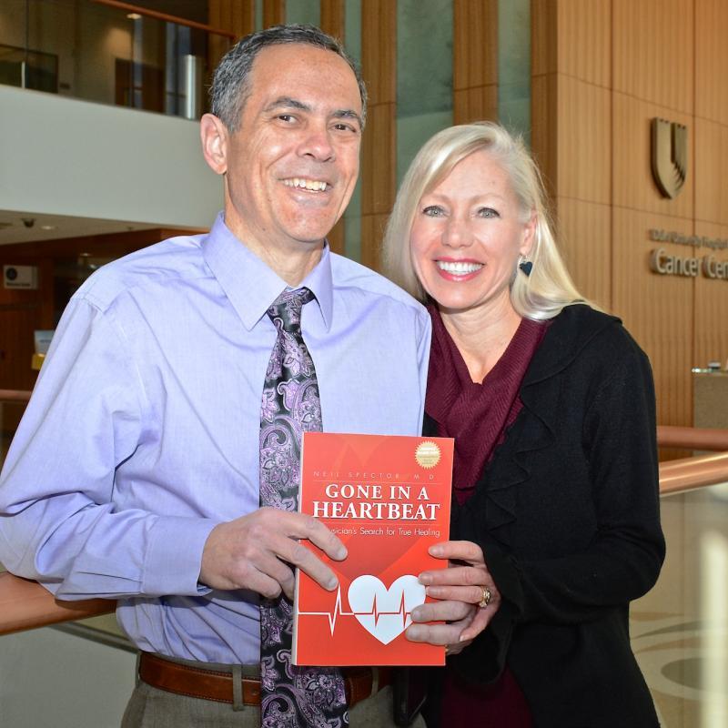 Neil Spector, MD, and his wife, Denise Spector, PhD, posed with Neil's book, "Gone In A Heartbeat," 