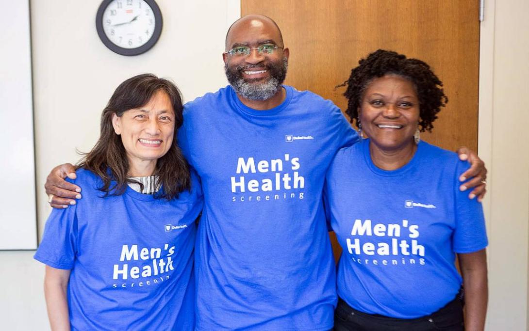 Staff with the Office of Health Equity wear Men's Health shirts