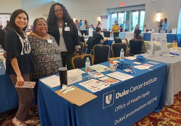 DCI Office of Health Equity's community-facing patient navigators meet members of the community at a health event. Left to right: Dalia Antunez, Kimberly Bradsher, and LaSonia Barnett.